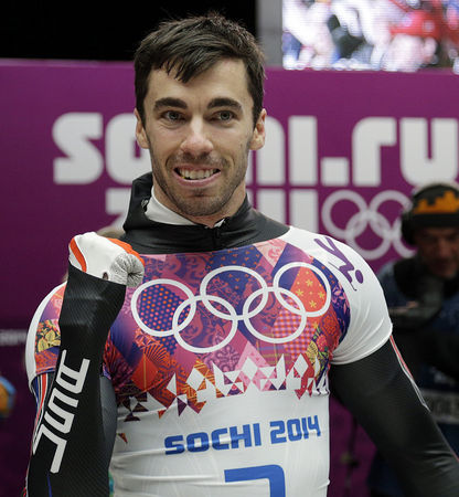 Matt Antoine of the U.S. celebrates after winning bronze in the men's skeleton at the Sochi Olympics in Krasnaya Polyana, Russia. (AP Photo/Michael Sohn)