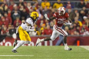 Wisconsin RB Melvin Gordon does the Heisman pose on Minnesota's Briean Boddy. PHOTO: Jeff Hanisch, USA TODAY