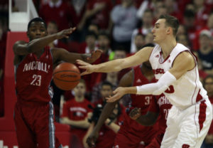 Wisconsin forward Sam Dekker (15) passes as Nicholls State guard Quinton Thomas (23) defends. PHOTO: Mary Langenfeld, USA TODAY