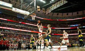 Bronson Koenig (24) drives to the basket against Michigan at the United Center. PHOTO: Bob Campbell