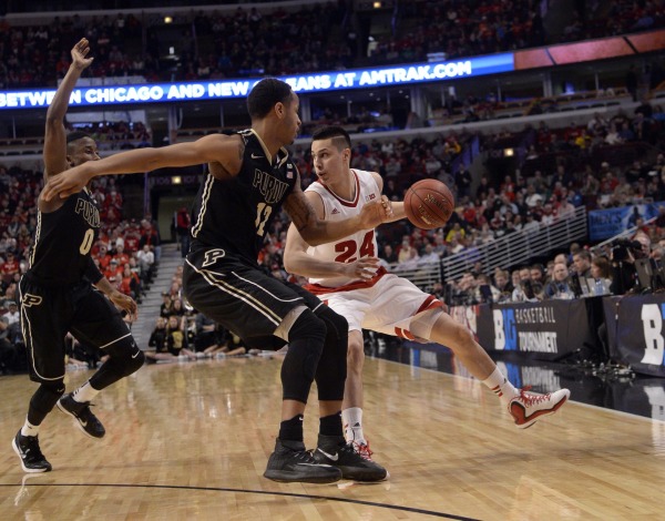 Wisconsin guard Bronson Koenig (24) controls the ball against Purdue forward Vince Edwards (12) and guard Jon Octeus (0) during the second half in the semifinals of the Big Ten Tournament at United Center. PHOTO: David Banks, USA TODAY